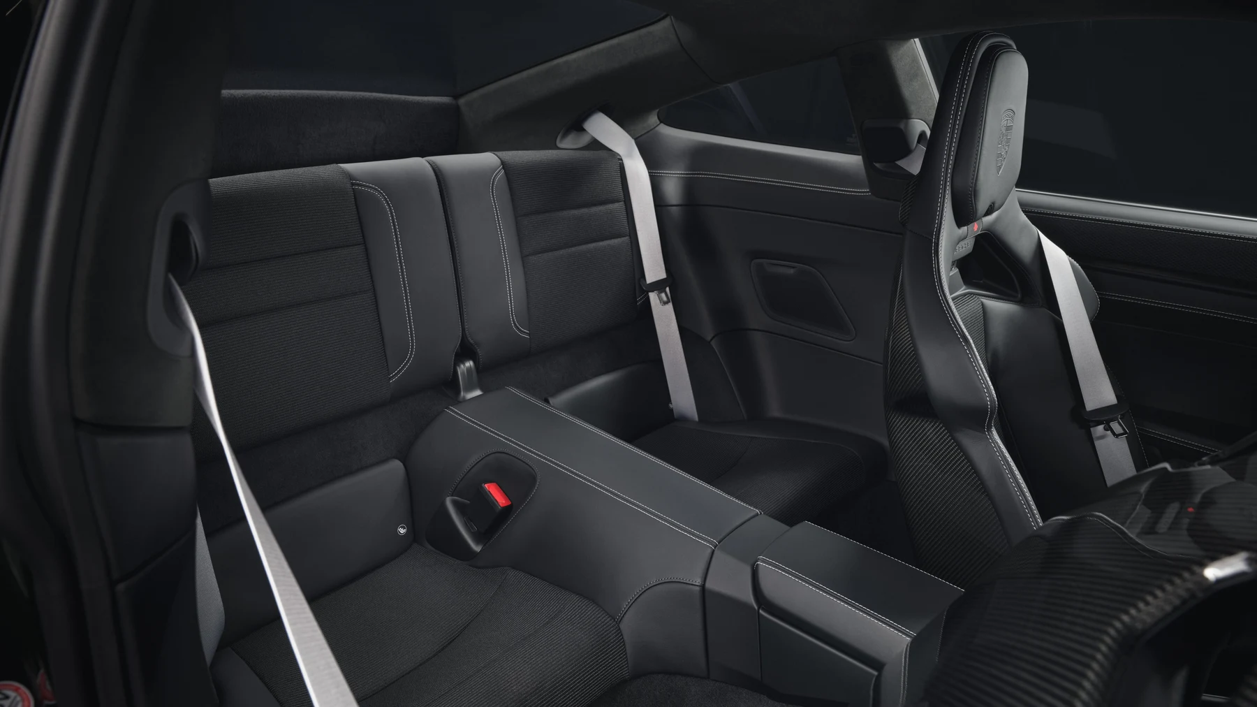 View into the 911 GT3 Touring rear cabin, with the rear seat system and front bucket seat visible.